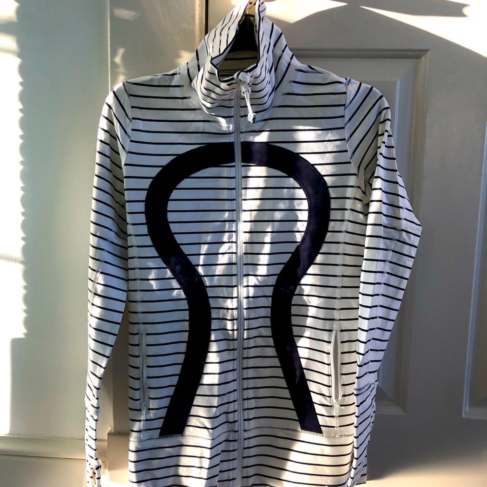 Almost new. Worn once! Lululemon size 6 zip up jacket. White w/ Navy stripes.